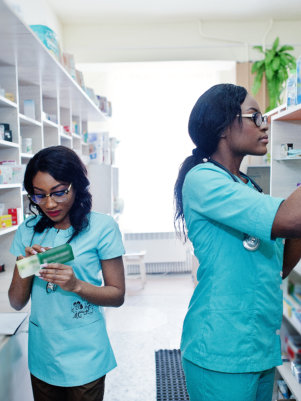 two pharmacist putting medicine