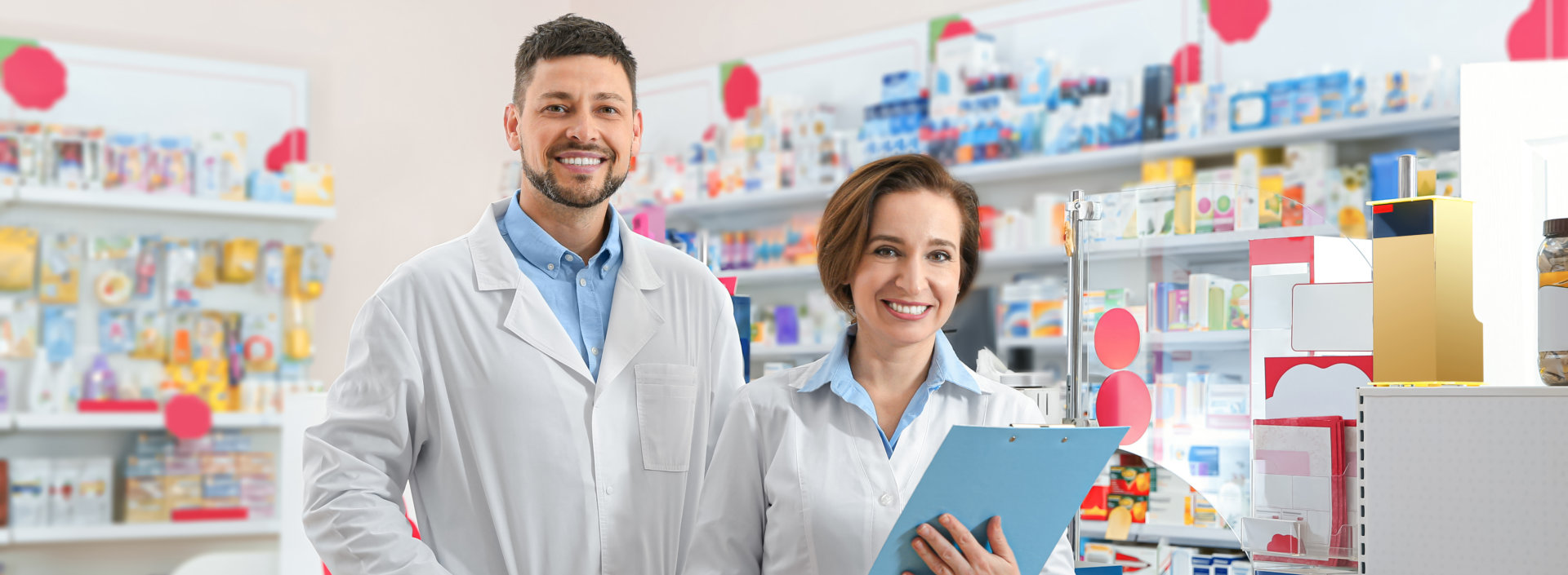 two pharmacist smiling at the camera